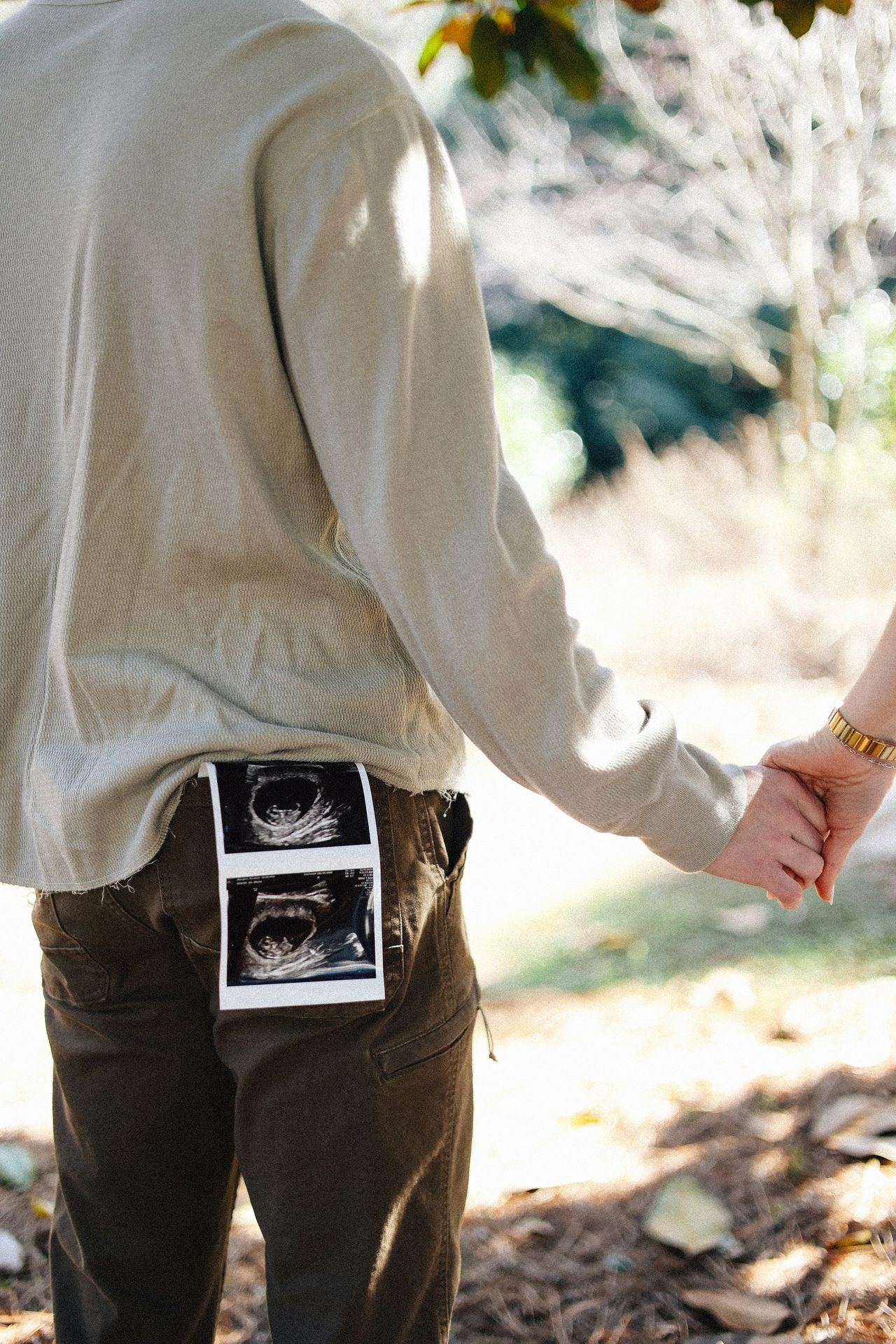 Expecting parents showing ultrasound images.